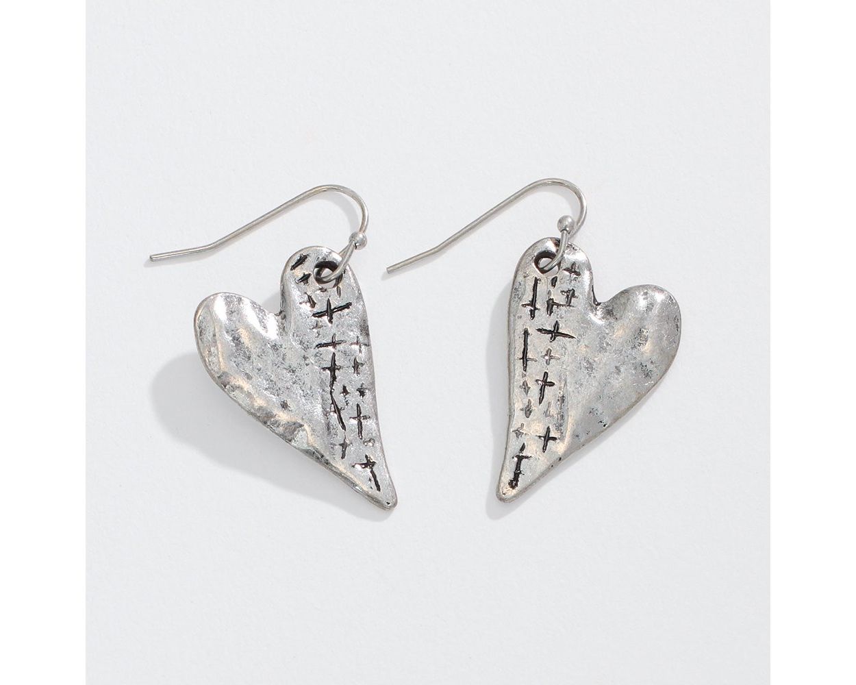 Hammered silver hearts with etchings