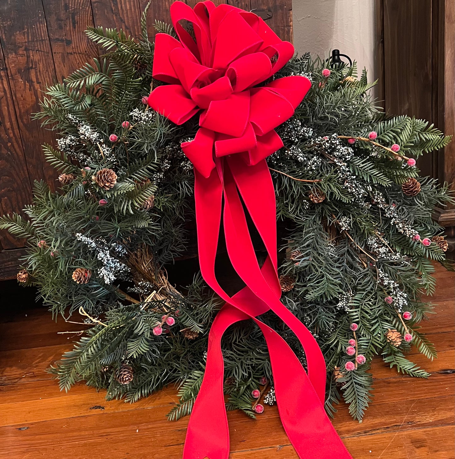 Red bow wreath with red berries