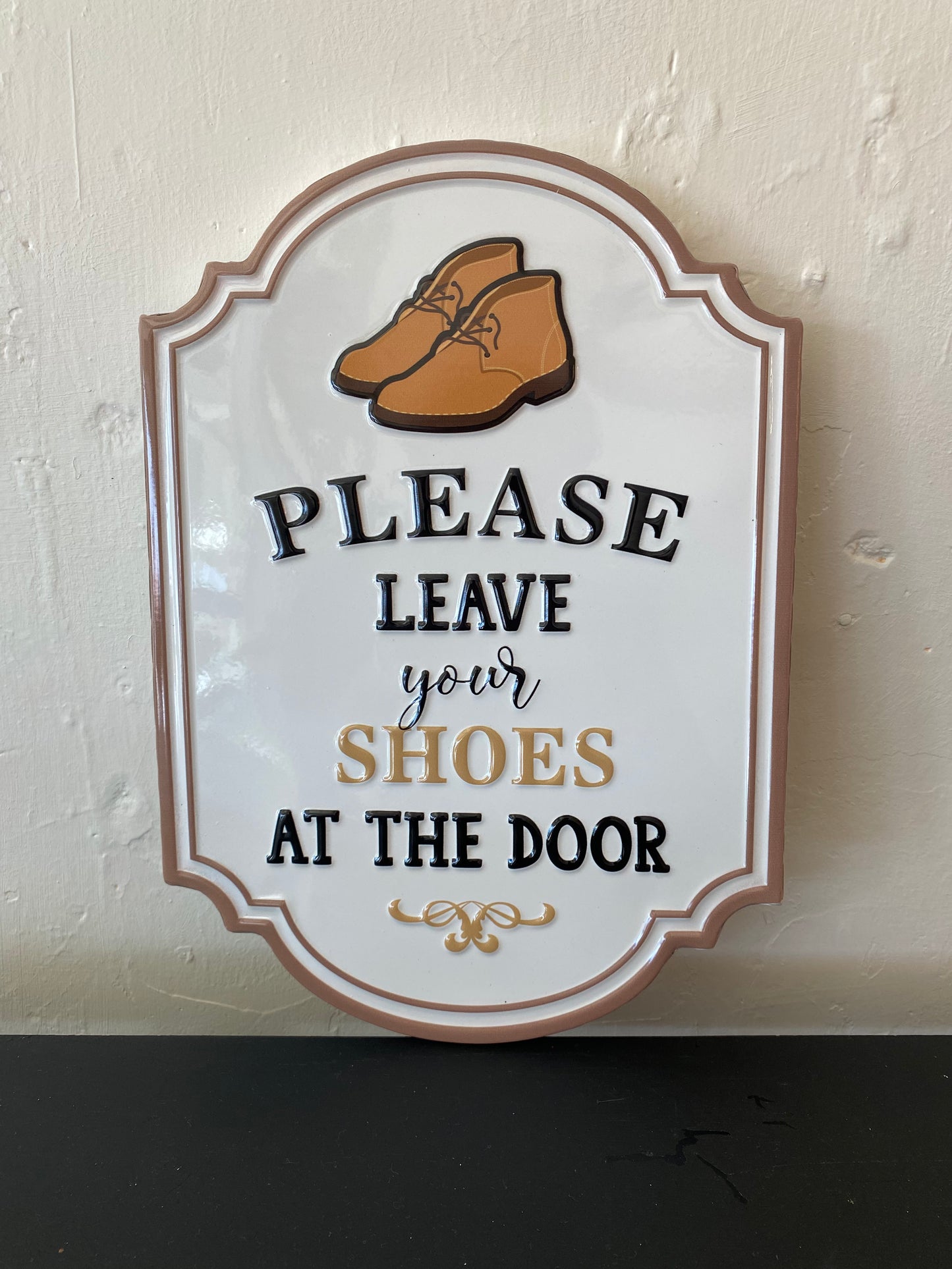 Please leave your shoes at the store sign